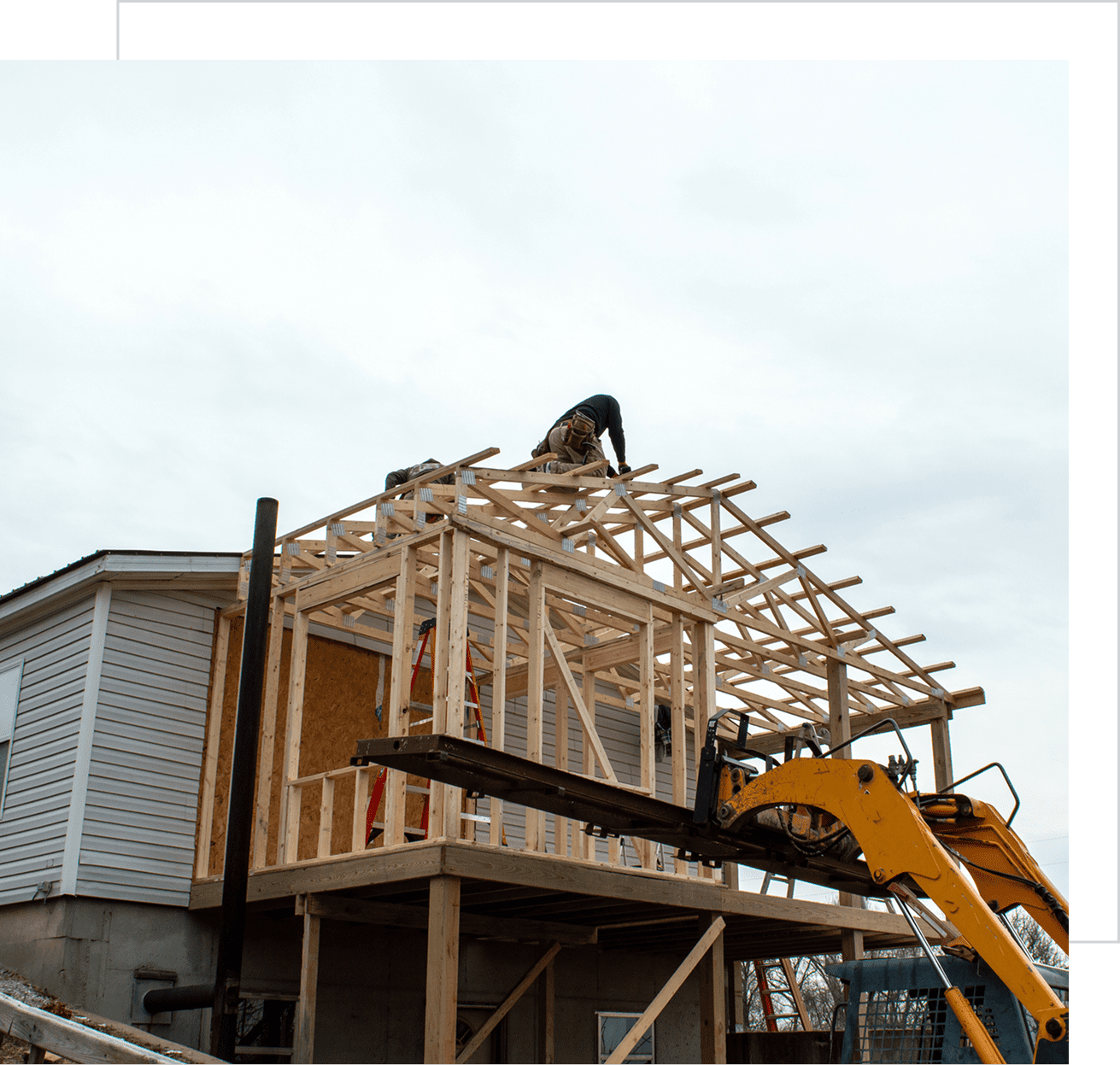 Construction worker building house roof framework